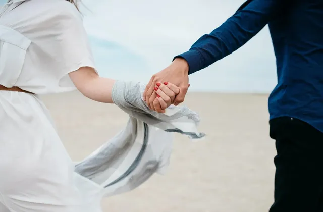 Two people holding hands