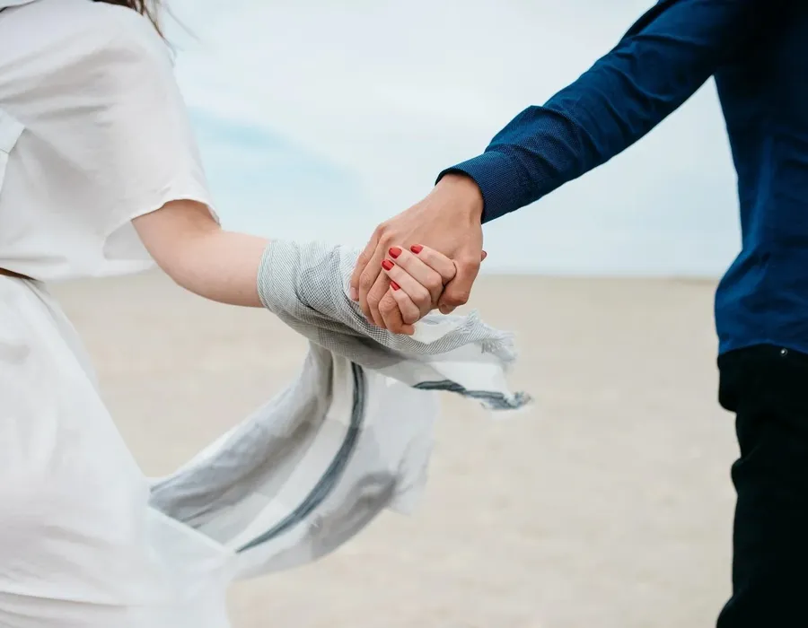 Two people holding hands