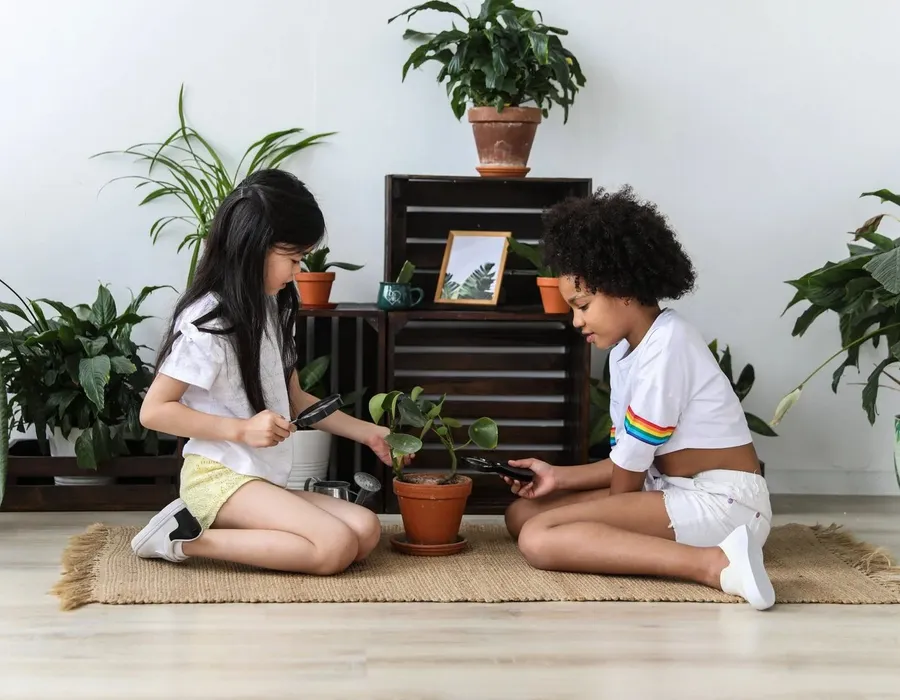 Two children tending plants together