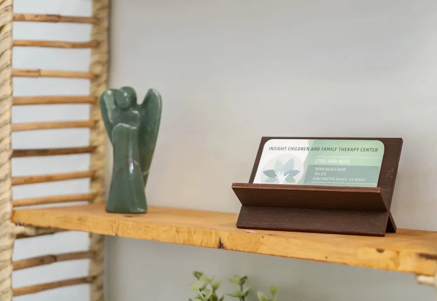 Wooden shelf with a decorative figure and a framed sign