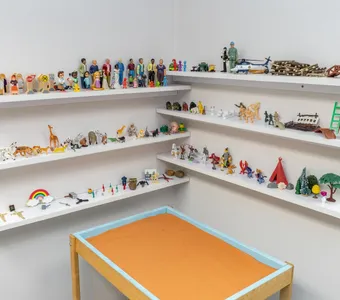 Sand-tray miniatures on shelves