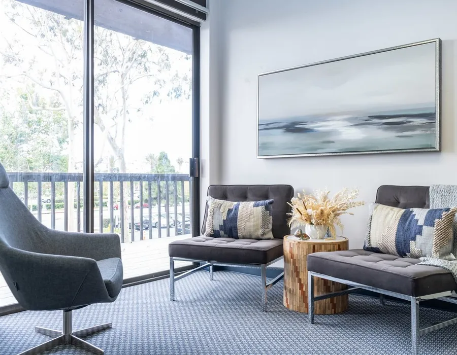 The waiting area at Insight with armchairs and a view of the trees