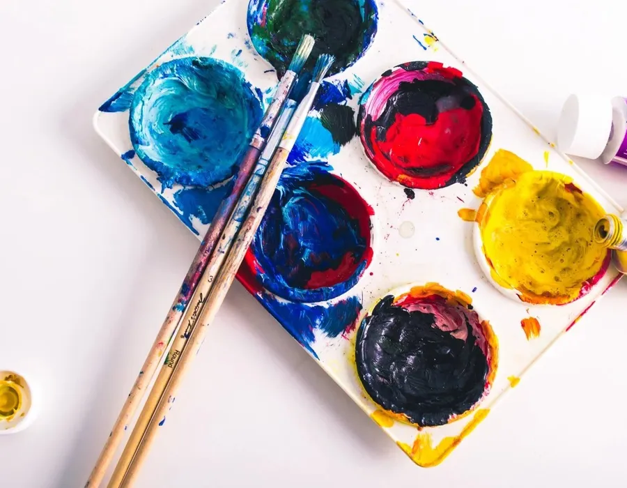 A watercolor palette and brushes