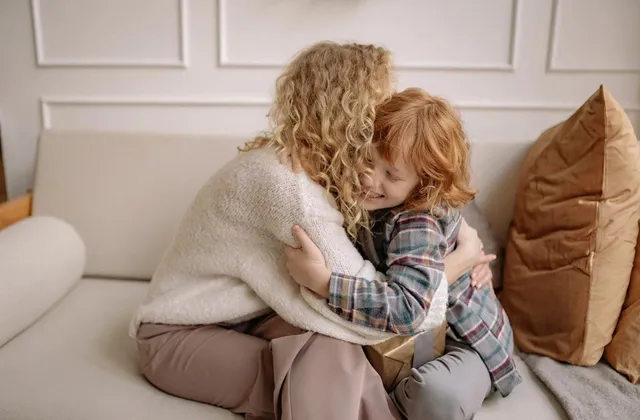 A parent and child sharing a close moment on the couch