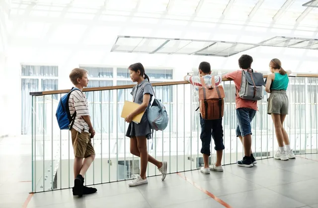 A group of teens talking together outdoors
